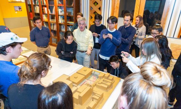 people in room looking at architectural model
