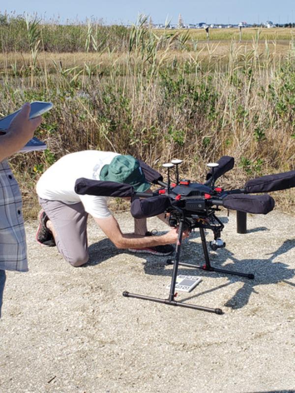 Person working with equipment in a field.