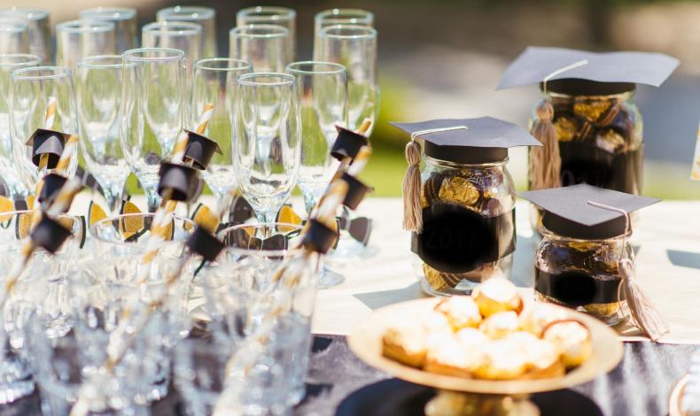 champagne glasses with graduation hats